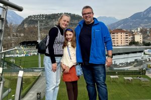 Família Darugna no terraço do MUSE em Trento, com montanhas dos Alpes ao fundo